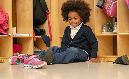  Little boy sitting on floor